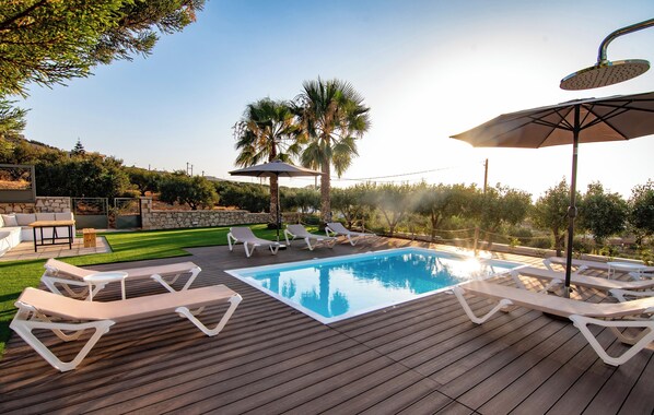 A wooden deck with a swimming pool, lounge chairs, and umbrellas. - VILLA PELAGOS VIEW,PRIVATE POOL,4 BEDROOM, 5 min from the beach! (Crete)