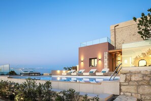 A modern poolside area with lounge chairs and a clear view of the ocean. - Historic Beauty & Nature at Balarina by etouri (Chania)