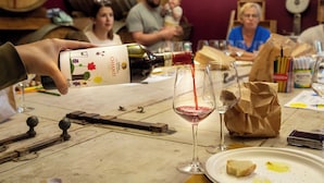 A wine tasting event with a focus on a bottle being poured into a glass. -  Palagina Il Borgo Agricolo (Figline e Incisa Valdarno)
