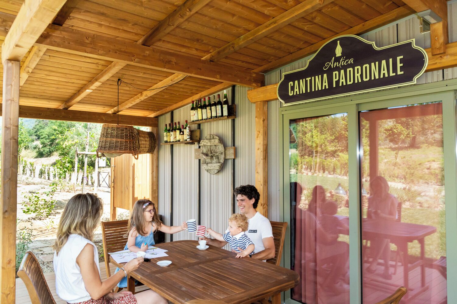 A wooden outdoor seating area with a sign reading "Cantina Padrona."