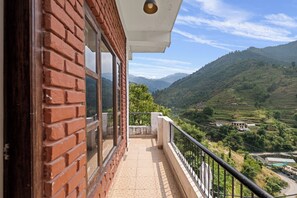 Deluxe Room With Garden View | Premium bedding, desk, laptop workspace, free WiFi - Hotel Sun Village by Palm Aryan (Mussoorie)