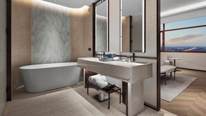 Une salle de bain moderne avec une baignoire sur pieds, un meuble-lavabo doté d’un grand miroir et une vue sur le paysage urbain grâce à de grandes fenêtres.