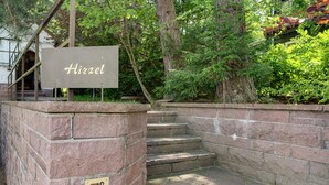 A stone staircase leading to a building entrance with a sign reading 'Hirzel.' - Holiday Apartment 'No. 10' with Mountain View and Private Terrace; additional dogs upon request (Bad Wildbad)