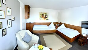 A hotel room with two beds, a sofa, a TV, and a wardrobe. - Lake Constance Bliss Apartment with Private Terrace (Überlingen)