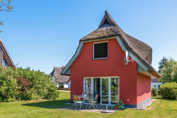 Exterior View of a Red Holiday House with Terrace