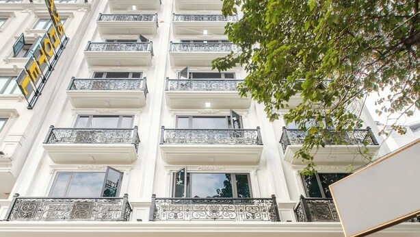 A multi-story hotel with a grand entrance, marble steps, and a sign indicating it is a hotel. - A25 Hotel - Hoang Dao Thuy 2 (Hanoi)