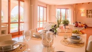 A dining area with a table set for two, featuring a wine bottle, glasses, and a fruit bowl. - My Rental Homes - Villa Cremia  with infrared sauna, Jacuzzi and lake view (Vignola)