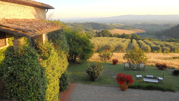 A villa with a view of rolling hills and vineyards.