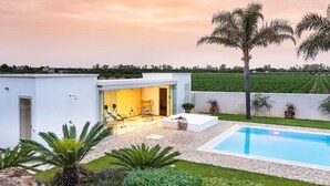 A modern house with a patio, a swimming pool, and a garden. - Sun Stone with garden and pool - My Rental Homes (Trapani)