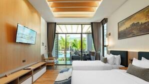 A modern hotel room with a large bed, a TV mounted on the wall, a desk, and a view of the pool and palm trees. - A.Z. Sunrise Resort & Fitness Club (Choeng Thale)