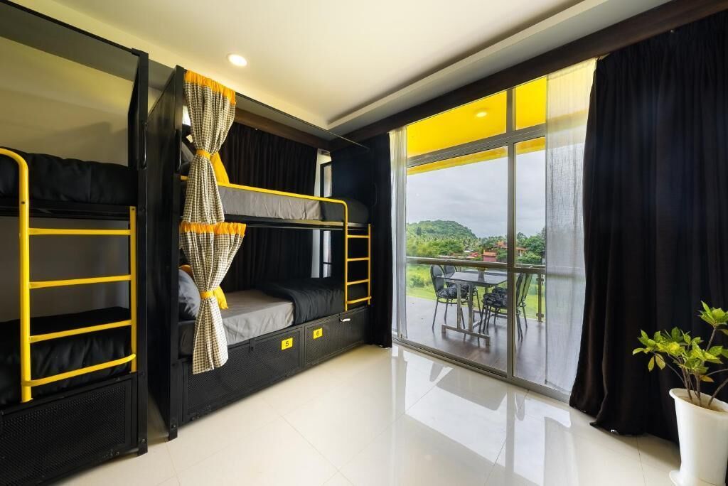 A bunk bed room with a view of the outdoors.