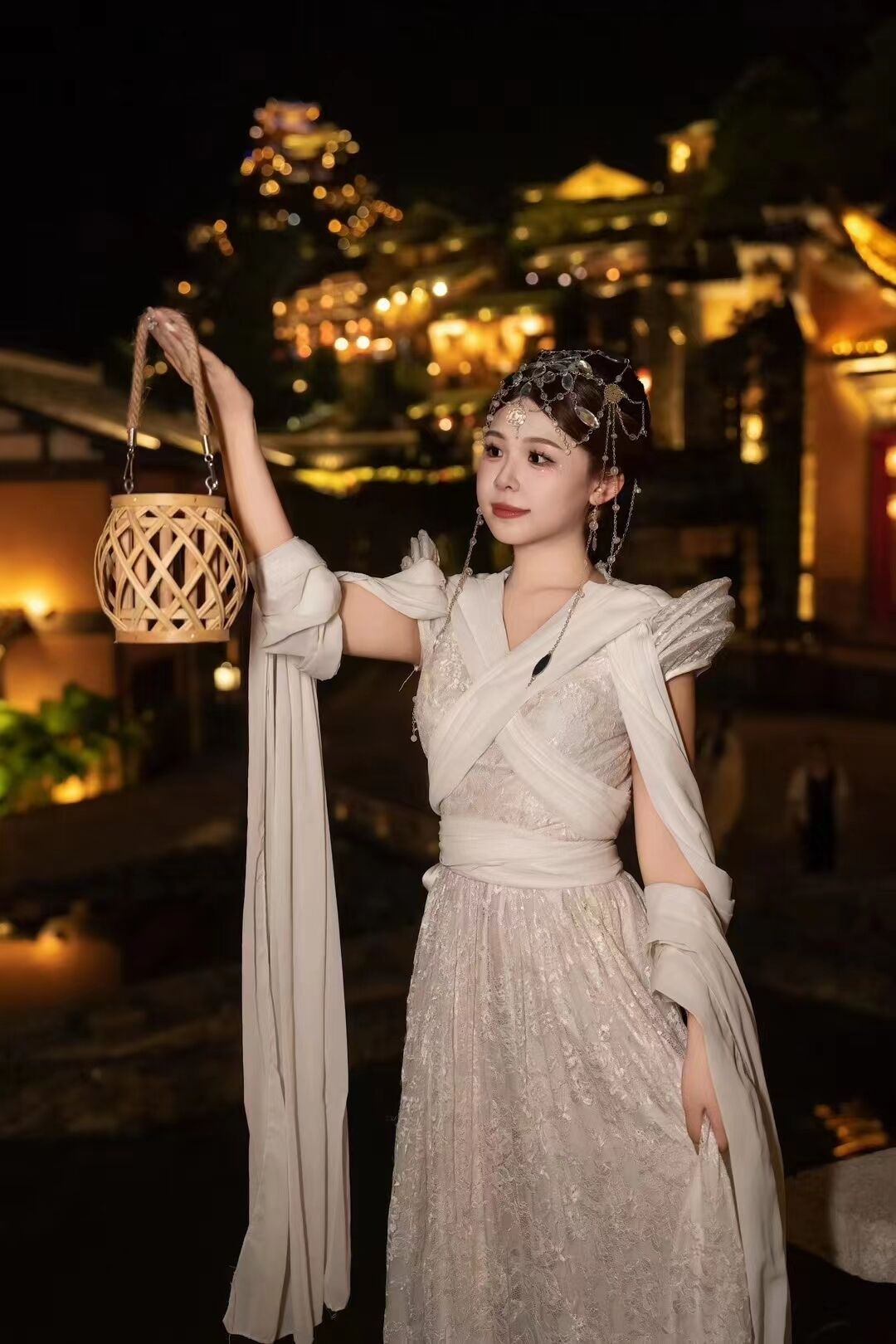 A person in a traditional dress holding a woven basket.
