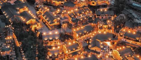 A traditional village with numerous buildings, a central circular structure, and a dense arrangement of pathways.