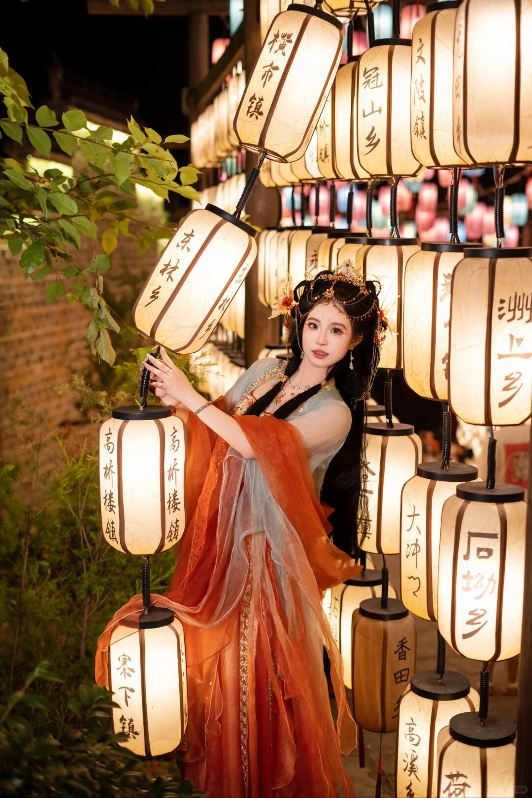 A person in traditional attire holding a lantern with Chinese characters.