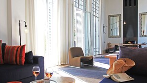 A modern living room with a sofa, armchair, and a dining area with a table and chairs. - My Rental Homes - Villa Susan with heated pool and large garden (Marrakesh)