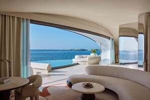 One Bedroom Overwater Villa | Living area | 65-inch Smart TV with satellite channels