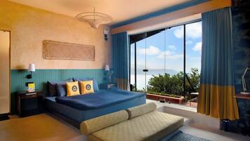 A bedroom with a large bed, a view of the outdoors, and a balcony.