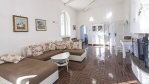 A spacious living area with a sofa set, a coffee table, and a fireplace. - Villa Cardinale  in Salento with pinewood and swimming pool. Puglia. (Puglia)