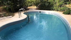 A swimming pool with a metal ladder and a small window at the bottom. - Villa Cardinale  in Salento with pinewood and swimming pool. Puglia. (Puglia)