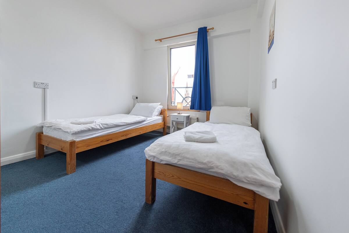 Twin room disability access room | Blackout drapes, iron/ironing board (on request), cribs (free)
