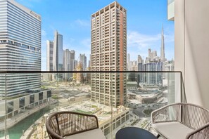 A balcony with a view of a cityscape, including high-rise buildings and a marina.