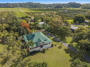 Situated in a peaceful rural setting, this single-story building offers a serene escape surrounded by lush greenery and expansive fields.