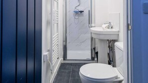 A narrow bathroom with a shower, toilet, and sink. - Fabulous 6 bedroomed, all en-suite accommodation (Hartlepool)
