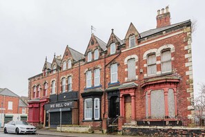 A row of red brick buildings with Victorian architectural features, including pointed roofs and decorative window frames. - 5 Bedroom House in Hartlepool (Hartlepool)