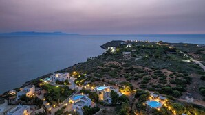 A coastal resort with multiple villas, a swimming pool, and a view of the sea. - Luxury 3 bedroom Villa with heated pool (Akrotiri)