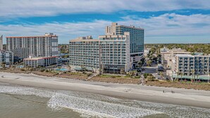 A coastal hotel complex with multiple high-rise buildings, a beachfront, and a parking area. - Sand Dunes Resort Unit 1406 - Ocean View! (Myrtle Beach)