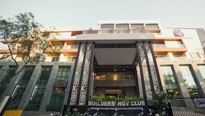 A modern building with a prominent entrance, large windows, and decorative pillars. - BNGV Grandeur Hotel & Banquets (Bengaluru)