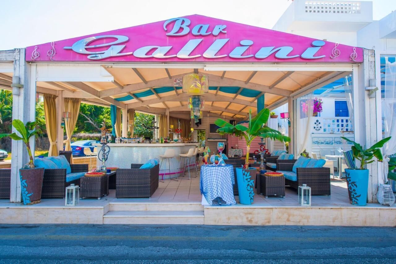 A bar named 'Bar Gallini' with outdoor seating and a covered patio area.