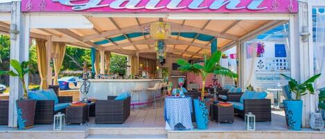 A bar named 'Bar Gallini' with outdoor seating and a covered patio area.