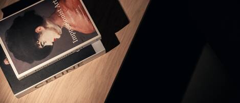 A book titled "Impressions of Art" on a wooden surface.