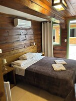 Economy Triple Room | Living area | 30-inch TV with cable channels