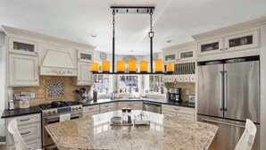 A modern kitchen with a granite island, stainless steel appliances, and white cabinetry. - Forest Retreat | 25 Min to Stratton (Windham)