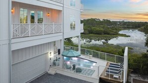 A multi-story building with a balcony and a pool. - LakeFront w/ LSV, Bikes, Pool, & Game Room! STEPS to Beach! Sleeps 20, Pet Friendly! (Santa Rosa Beach)
