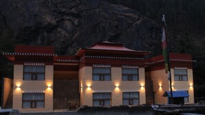 Ein Gebäude mit einer symmetrischen Fassade, zahlreichen Fenstern und einer Fahnenstange.