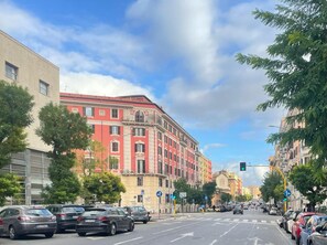 A street view with parked cars, buildings, and a traffic light. - Z-Archsuites - URBE (Rome)