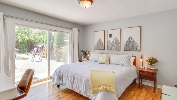A bedroom with a large bed, a desk, and a chair. There are three framed pictures on the wall. - 24 Mi to Slopes! Family Reno Home w/ Outdoor Oasis (Reno)