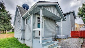A two-story house with a front porch, steps leading to the door, and a satellite dish on the roof. - 3 Mi to Dtwn Tacoma: Pet-friendly Home (Tacoma)