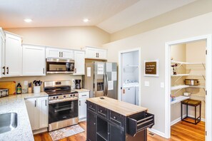 A modern kitchen with white cabinets, stainless steel appliances, and a wooden island. - 8 Mi to Ark Encounter: Family Home w/ Deck & Grill (Dry Ridge)