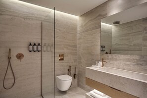 Suite | Bathroom | Shower, hair dryer, slippers, towels