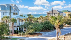 A coastal residential area with houses, palm trees, and a clear sky. - Private Pool | Pet Friendly | Sleeps 10 | Gulf Views (Cape San Blas)