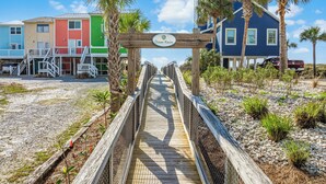 A wooden boardwalk leading to a beach house with a sign reading "Ocean Haven." - Private Pool | Pet Friendly | Sleeps 10 | Gulf Views (Cape San Blas)