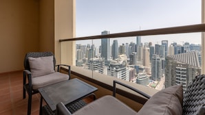 A balcony with a city view, a table, and two chairs. - Trendy JBR 2BR w Pool and Gym Marina Views (Dubai)