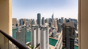 A high-rise cityscape with modern skyscrapers, a marina, and a clear sky. - Trendy JBR 2BR w Pool and Gym Marina Views (Dubai)