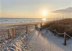 A sandy beach path with a wooden fence and rope barrier, leading to the ocean. - Seaworthy-Oceanfront 3 Br/3 Ba, Beachwalk Villa Panoramic oceanview, elevator (Pine Knoll Shores)