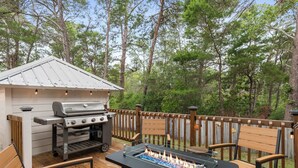 An outdoor deck with a grill, a fire pit, and wooden furniture. - Community Pools | LSV | Close to Beach (Santa Rosa Beach)