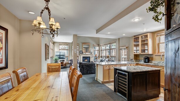 A spacious kitchen with a dining area, wooden cabinets, and a central island. - Fantastic Mountain Home Near Ski Lifts 3 Bedroom Condo (Keystone)